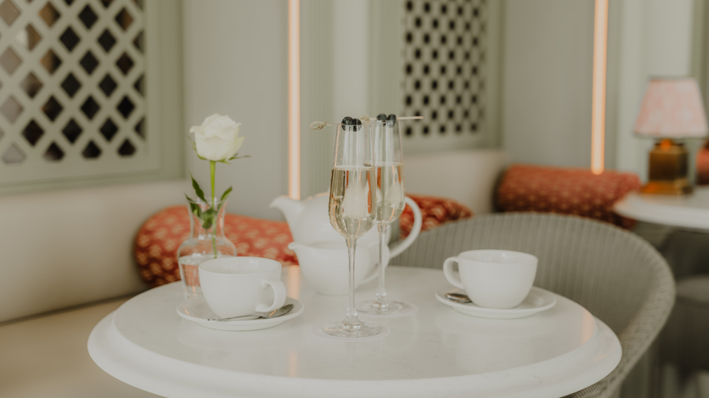 Table with two tea cups as well as two champagne flutes