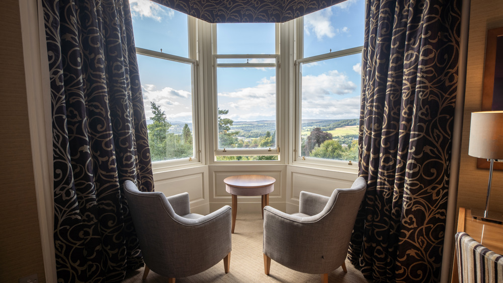 Feature Family room with two chairs facing a bay window